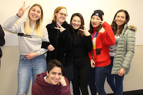 Photo of a group of Chatham University international students posing together with smiles