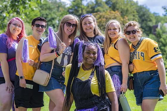 Photo of a group of Chatham University students outside together outside wearing Pittsburgh Pirates gear and Chatham T-Shirts. 